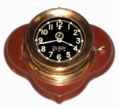 C.1940, (dated) Chelsea Clock Co., Mark I Deck Clock, Navy contract, serial no 7415, accompanied by a brass medallion from the United States LST Association. This clock was sent to us from Florida, and the consignors relative allegedly removed the clock from an LST during WWII. — Antique Clocks Price Guide