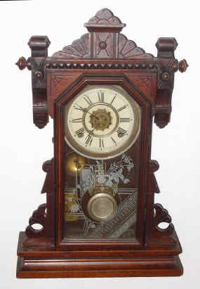 C.1891, Waterbury Clock Co., JENNER, walnut cased gingerbread clock, 8-day gong strike with alarm. — Antique Clocks Price Guide