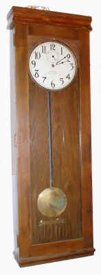 C.1920, International Time Recording Co., MASTER CLOCK , electrically wound, in a dark oak case, seconds pendulum. — Antique Clocks Price Guide