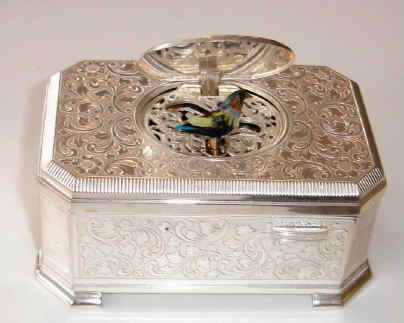 Late 20th Century, German/Swiss, singing bird box, key wound from bottom, in a silver plated embossed case. — Antique Clocks Price Guide