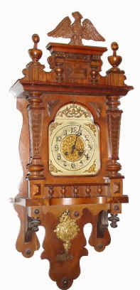 C.1905, German, Berliner or open well free swinger, with arch silvered dial with brass spandrels and with fancy cast brass pendulum. — Antique Clocks Price Guide
