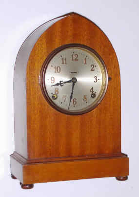 C.1930, E. Ingraham and Co., Rounded Gothic Shelf Clock, 8-day time and gong strike with half hour bell, dial with raised numerals. — Antique Clocks Price Guide