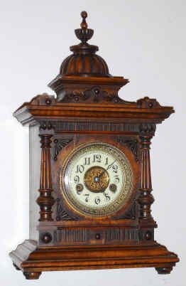 C.1900, German, Hamburg-American Clock Co., medium walnut mantel clock, 8-day time and gong strike with porcelain dial. — Antique Clocks Price Guide