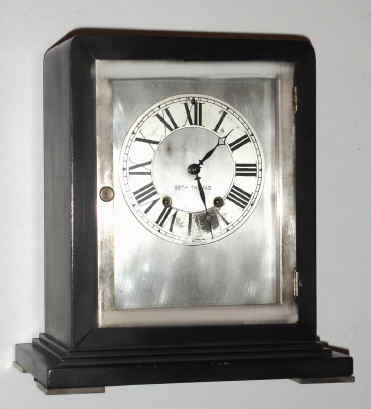 C.1929, Seth Thomas, black enameled wood with silvered brass door and feet, 8-day time and gong strike with round No. 120 movement. [Nearest model we find is the Ritz]. — Antique Clocks Price Guide