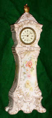 C. 1890 New Haven Clock Co.?, 30-hour miniature porcelain tall clock. This case may have a replaced movement as an example of this case appears in an Ansonia catalog with the number 2516. — Antique Clocks Price Guide