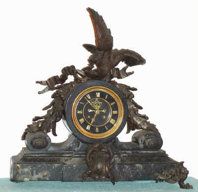 C.1890, French, Patinated White metal and marble mantel clock, a large spread eagle defending his perch of oak branches/acorns, the movement with black slate dial and raised gilt numerals, and with open escapement. — Antique Clocks Price Guide