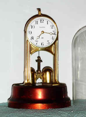 C.1904, Tiffany Electric Mfg Co., Buffalo, NY, "NEVER WIND" battery timepiece with torsion pendulum. — Antique Clocks Price Guide