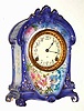 C.1904, Ansonia Clock Co., Royal Bonn La Cruz, porcelain china clock in a royal purple color, with floral accents.