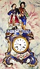 C.1850, French, Porcelain Mantel clock, two piece, with costumed lovers on top, the base color blue cobalt accented with gold highlights and floral displays. The silk thread bell strike movement with countwheel, 8-day.
