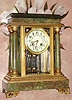 C.1895, French, Japy Freres, Ormolu and Onyx, 4-glass "Crystal Regulator", with 4 free standing onyx columns, onyx base and top, the whole with gilt cast bronze capitals and accent trim, and with a creamy porcelain dial w/ polychrome decorations, and original 2-vial compensating pendulum.