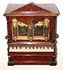 C.1860, Swiss or Austrian, Musical Jewel box in the form of an organ, two drawers locked behind the rank of silvered brass pipes attached to the front doors. Music is actuated by simply pressing the keyboard, when it plays one of 2 tunes and stops; key-wound from the rear.