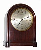 C.1900, Winterhalder and Hofmeier, 8-day 3-tr, Westminster chime mantel clock retailed by Bailey, Banks and Biddle Co., Philadelphia, in a round Gothic mahogany case, with silvered dial.