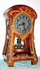 C.1905, German, Jahresuhrenfabrik, Model 218, Art Nouveau timepiece in a cherry case with copper colored brass cast decorations both front and sides, and with disc pendulum.