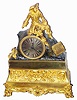 C.1840, French, Bronze and Ormolu Figural clock of a gentleman in 1820's ruffled pantaloons, a feather in his hat and fancy boots. At his feet rests a docket of papers, with clasps. He is resting on a "rock" which contains the clock.