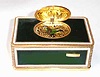 Late 20th Century, German/Swiss, singing bird box in a dark green enameled case, with engraved and gilded corners and edging.
