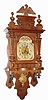 C.1905, German, Berliner or open well free swinger, with arch silvered dial with brass spandrels and with fancy cast brass pendulum.