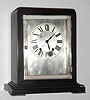 C.1929, Seth Thomas, black enameled wood with silvered brass door and feet, 8-day time and gong strike with round No. 120 movement. [Nearest model we find is the Ritz].
