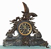 C.1890, French, Patinated White metal and marble mantel clock, a large spread eagle defending his perch of oak branches/acorns, the movement with black slate dial and raised gilt numerals, and with open escapement.