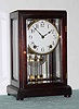 C.1917, New Haven Clock Co., "TUXFORD", "5-glass" mantle regulator, a slender mahogany case with beveled glass all around, and faux mercury pendulum, large round movement with rack and snail on rear plate.