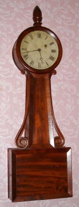 Unsigned Attleboro banjo clock, with carved mahogany side arms, 8-day, weight driven, C.1850. — Antique Clocks Price Guide