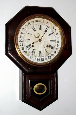 Ansonia Clock Co., short drop octagon, time and gong strike school clock with calendar, rosewood veneer. C. 1900. — Antique Clocks Price Guide