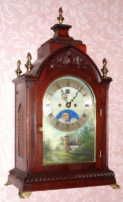 English, 2-Fusee, Bell Strike bracket clock, with painted arched dial, Halifax moon above 6 and with calendar aperture below 12, mahogany case with flame finials and brass side frets. C. 1860. — Antique Clocks Price Guide