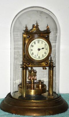 German, Jahresuhrenfabrik, 400 Day mantel clock with porcelain dial and glass dome, disc pendulum, dial signed Urania. C. 1908. — Antique Clocks Price Guide