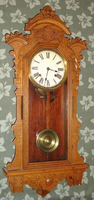 E. Ingraham and Co., "PACIFIC", fancy oak wall clock, 8-day, time and gong strike. C.1896. — Antique Clocks Price Guide