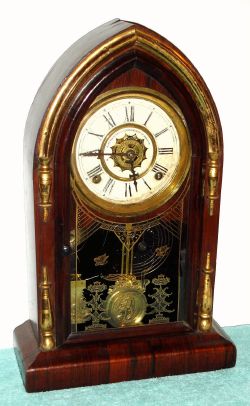 Waterbury Clock Co., "CORINTH GILT", rosewood mantel clock with gilt accents, 8-day time and gong strike, with bell alarm, spring C.1885 — Antique Clocks Price Guide