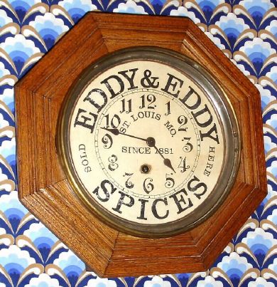 E. Ingraham and Co., solid oak octagon timepiece with paper advertising dial for "Eddy and Eddy Spices, St. Louis Mo, since 1881.", 8-day, spring (pendulum movement). C.1915. — Antique Clocks Price Guide