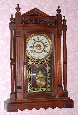 New Haven Clock Co., "VISTULA" walnut cased parlor clock with lots of turned trim and finials, 8-day, time, cathedral gong strike (heavy flat wire) and bell alarm. C.1885. — Antique Clocks Price Guide