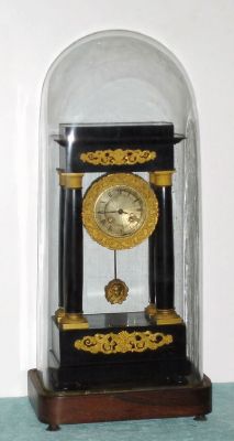 French, Empire-style black ebonized four column case with gilt ormolu surrounds and trim, spring driven brass mvt, excellent dome measures 24 1/2"H x 11"L x 7"W, clock measures 18"H. C. 1860. — Antique Clocks Price Guide
