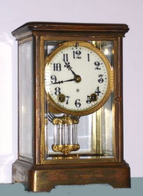 Ansonia Clock Co, 4 glass Crystal Regulator, plain corniche case, with solid porcelain dial, 8-day time and gong strike. C.1910. — Antique Clocks Price Guide