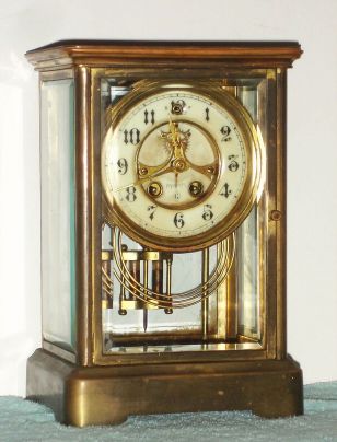 Wm. L. Gilbert Clock Co., Winsted, Conn, VALERIE, 4-glass crystal regulator, with open escapement on the porcelain dial, 8-day gong strike. C.1910. — Antique Clocks Price Guide