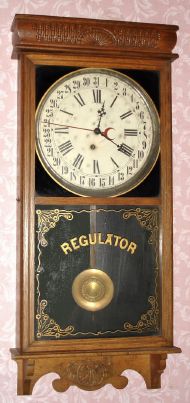E. Ingraham and Co, Bristol Conn, "WESTERN UNION" calendar model, 8 day time brass mvt store regulator in solid oak case with 12" dial, spring driven. C. 1907. — Antique Clocks Price Guide