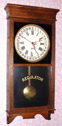Sessions Clock Co, Forestville, Conn, "REGULATOR NO. 2" calendar model, 8 day time brass mvt in oak case, spring driven. C. 1910. — Antique Clocks Price Guide