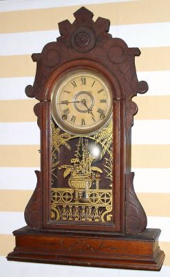 Geo. B. Owen, Winsted Conn, gingerbread mantel clock, 8 day time and strike on bell brass mvt in walnut case with 5" dial with center trim, spring driven. C. 1870. — Antique Clocks Price Guide