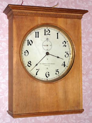 American Clock Company, Chicago Ill, electric time mvt in rectangular birch case, 13" dial with second's bit under 12 o'clock, designed to be electrically driven by two No. 6 dry cell batteries. C. 1920. — Antique Clocks Price Guide