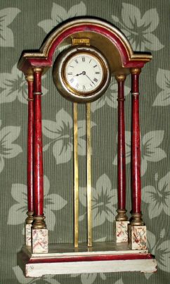 French, Gravity shelf clock with 8-day platform lever movement. The 4-column case has a toothed brass rail in the center, on which the weighted clock is supported. You raise the movement assembly to wind. C.1900. — Antique Clocks Price Guide