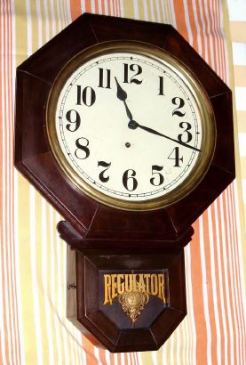 E. Ingraham and Co, Bristol Conn, "BRISTOL" short drop octagonal model, 8 day brass mvt in mahogany finish case with gilded French brass sash, 12" dial, spring driven. C. 1930. — Antique Clocks Price Guide