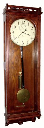 A probable Self-Wind full oak case with paneled sides, now with a large Seth Thomas weight movement that fits the original iron bracket perfectly. At first glance it looks similar to a No. 32, but that model has small columns the length of the case, and the door hinged inside, while this one is hinged at the outer edge, with molded door frame. C.1900. — Antique Clocks Price Guide