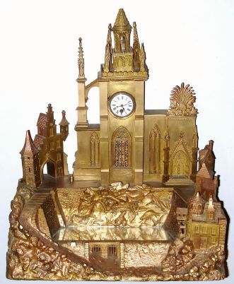 Mid 19th Century, French or Swiss, Clock in the form of a Cathedral complex, a mirrored pond in front of the church, formerly with music box, now absent. — Antique Clocks Price Guide