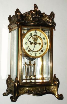Jennings Brothers, Chicago, IL, (made by Ansonia for Jennings retail establishment), 4-glass crystal regulator, 8-day gong strike with open escapement. C.1910. — Antique Clocks Price Guide