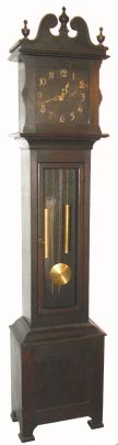 American, fumed oak tall case clock, probably by Ithaca Clock Co., 2-weight ladder chain movement striking on gong. C.1910. — Antique Clocks Price Guide