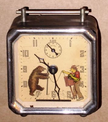 Keebler Clock Co., ORGAN GRINDER animated alarm clock, showing the grinders arm playing the organ briskly, opposite a bear in dance pose. C.1930. — Antique Clocks Price Guide
