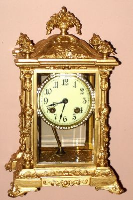 Ansonia Clock Co., NORMA, 4-glass crystal regulator, with Lever 'scape movement, 8-day time and strike, in a fancy cast case with Corinthian columns, C.1904. — Antique Clocks Price Guide