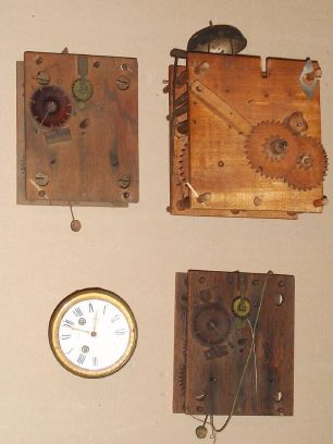 Box of 4 movements: mixed lot of two Terry type 30-hour wood shelf clock movements, French 8-day movement and dial and an Ashby type 30-hour tall clock movement. — Antique Clocks Price Guide