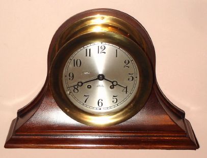 Chelsea Clock Co., CHELSEA model ship's bell clock on mahogany base/stand, serial 636644, 6" dial, hinged bezel with latch, C.1959 — Antique Clocks Price Guide