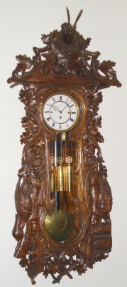 German, Carl Mueller, No. 104, Black Forest cased "Vienna Regulator", 3-wt, grand sonnerie, rod strike, in hunter motif, with rabbit, fox, 2-pheasant and a deer head, rifle and powder horn, all amongst sprays of oak branches and leaves, C.1890 — Antique Clocks Price Guide