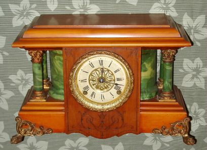 Seth Thomas Adamantine, the SHASTA, an unusual finish with clear cello over cherry or maple, this offset by the look of green onyx sides and columns. We have not seen this color combination before, C.1905 — Antique Clocks Price Guide